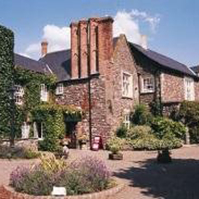 The exterior of the Priory Hotel, Caerleon showing flower beds and garden